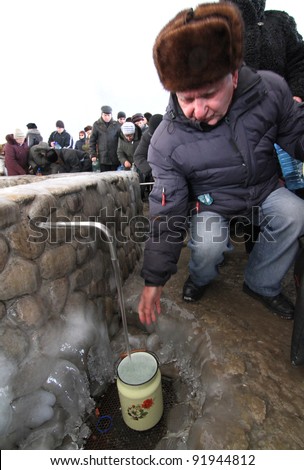 KHARKIV, UA - JANUARY 19: Unidentified Kharkov people draw water during Epiphany (Holy Baptism) in the Orthodox tradition, January 19, 2011 in Kharkov, Ukraine