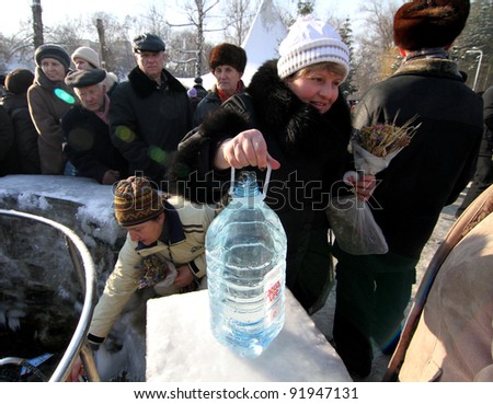 KHARKIV, UA - JANUARY 19: Unidentified Kharkov people draw water during Epiphany (Holy Baptism) in the Orthodox tradition, January 19, 2011 in Kharkov, Ukraine
