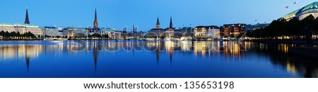 Panorama Picture Of The Binnenalster In Hamburg At The Blue Hour. The Dark Trees On The Right Side Keep The Viewers Attention Focused On The Center Of The Picture.