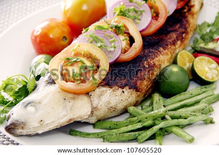 A grilled milk fish garnish with vegetables