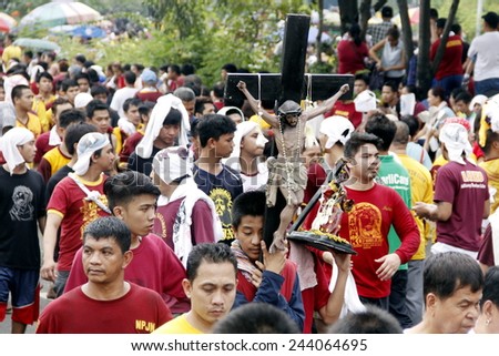 MANILA - JAN. 9: Devotees celebrate the feast of The Black Nazarene on January 9, 2015 in Manila Philippines. The fiesta celebrated with procession of image around the city by million devotees .