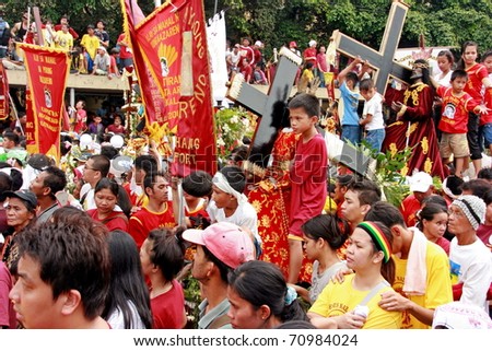 MANILA - JAN. 9: Devotees celebrate the feast of The Black Nazarene on January 9, 2011 in Manila Philippines. The fiesta celebrated by hundred thousand devotees parading the image in the city.