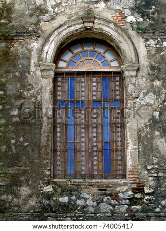 An old steel window on a concrete  frame