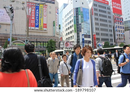 Tokyo, Japan - April 24, 2014 : Tourists and business people crossing the street at Harajiku