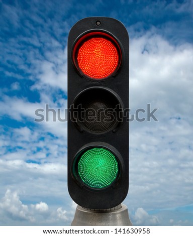 Red and Green traffic lights against blue sky backgrounds. Clipping Path included.