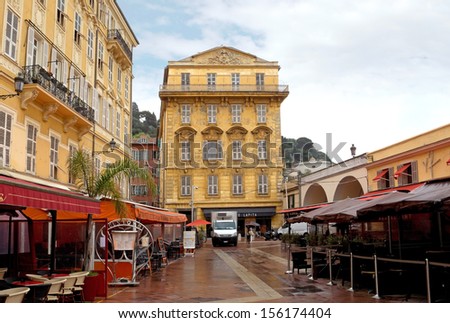 NICE, FRANCE - APRIL 27: Old building and a cafe in the Cours Saleya on April 27, 2013 in Nice, France. The Cours Saleya is a place of outdoor restaurants and a market.