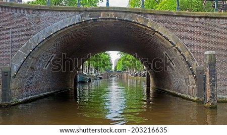 Romantic bridge over canal in old town. Amsterdam, Holland, Netherlands.