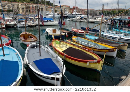 NICE, FRANCE - MAY 31: Colorful boats and buildings within a Port de Nice on May 31, 2014 in Nice, France. Port de Nice was started in 1745.
