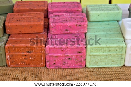 NICE, FRANCE - JUNE 8, 2014: Different flavored bars of soap from Marseille on a farmer\'s market.