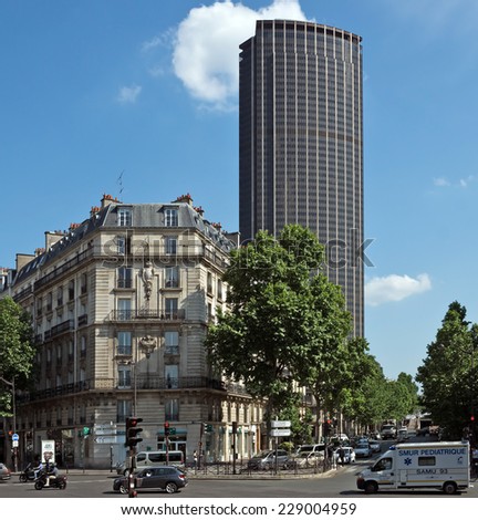 PARIS, FRANCE - JUNE 11, 2014: The architecture of the old and modern Paris. View of old building and Tour Montparnasse. Tour Montparnasse was constructed 1969 - 1972 by architect Eugene Beaudouin.