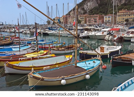 NICE, FRANCE - MAY 31, 2014: Colorful buildings and boats within a Port de Nice in French Riviera. Port de Nice was started in 1745.
