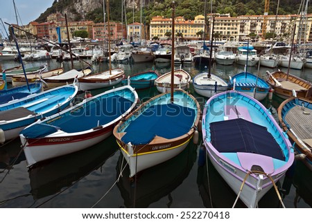 NICE, FRANCE - MAY 31: Colorful boats and buildings within a Port de Nice on May 31, 2014 in Nice, France. Port de Nice was started in 1745.