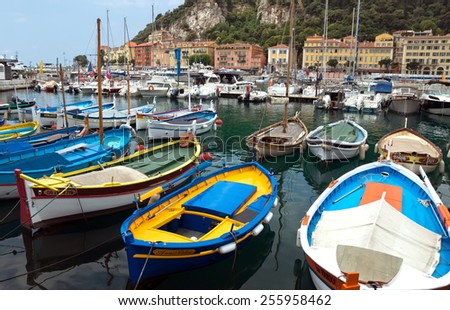 NICE, FRANCE - MAY 31, 2014: Colorful buildings and boats within a Port de Nice in French Riviera. Port de Nice was started in 1745.
