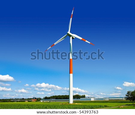 Wind turbine generating electricity on the beautiful green meadow.