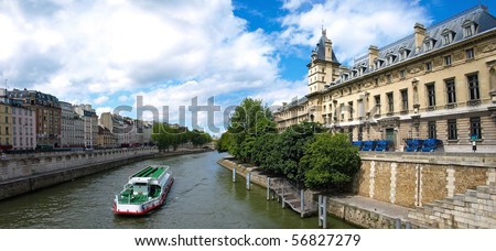River seine with water bus and famous quay des Orfe`vres in Paris where the judicial police