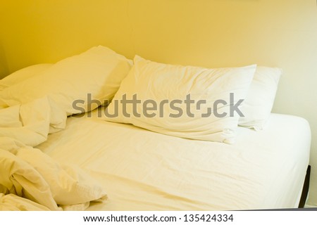 Pillows and blankets on the bed after waking up, Messy bed.