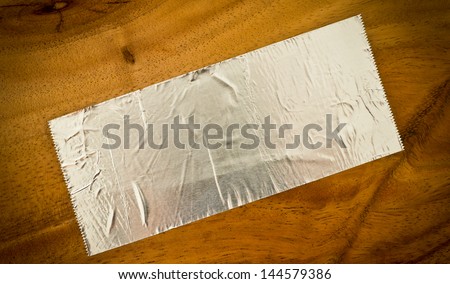 Paper foil on wooden background