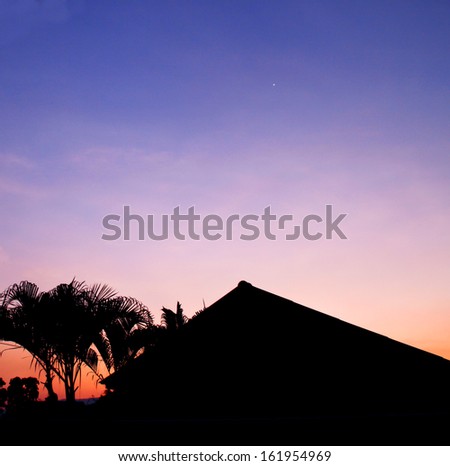 House silhouette with sunset sky background
