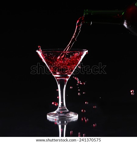 red splashing cocktail on black.