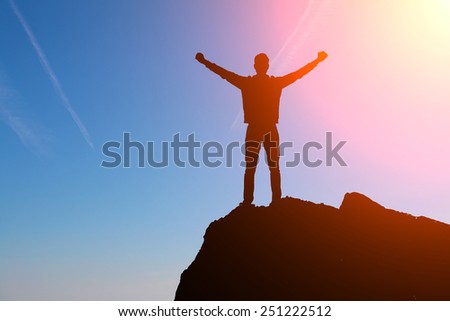 man at the top of the mountain