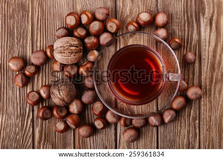 Autumn harvest. nuts on a dark recycled wood background, with copy space .. Top view of tea, nuts