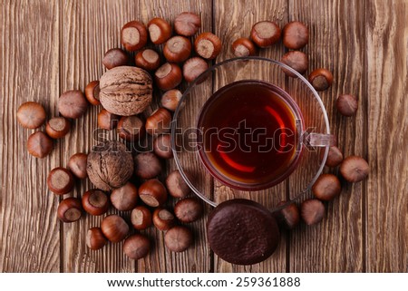 Autumn harvest. nuts on a dark recycled wood background, with copy space .. Top view of tea, nuts