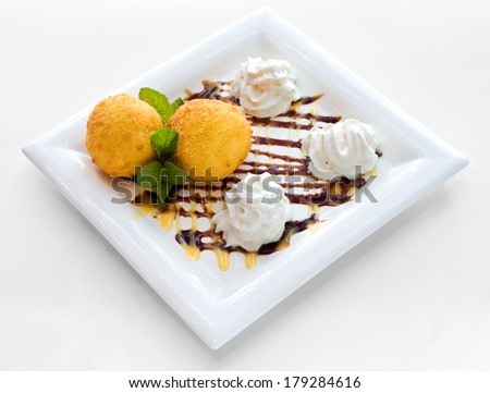 Sweet dessert with cream and cottage cheese balls poured with chocolate glaze