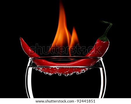 Red burning pepper in a glass with alcohol also burns with fire