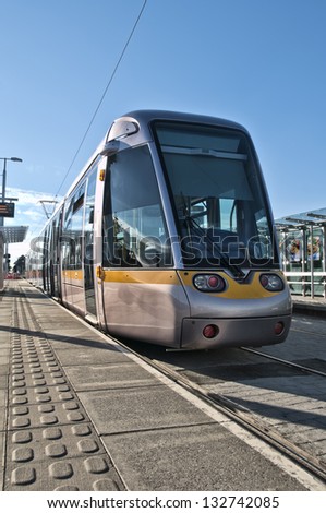 A Luas tram train pulling into a station in South County Dublin, Ireland.
