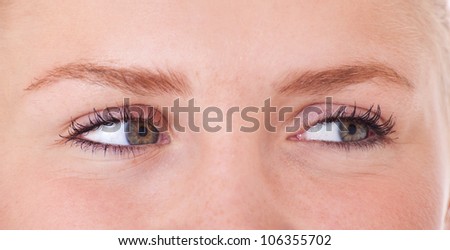 Eyes of an attractive teenage girl looking to the side. All on white background.