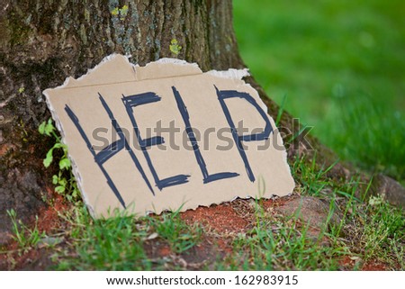 Cardboard sign showing the term help