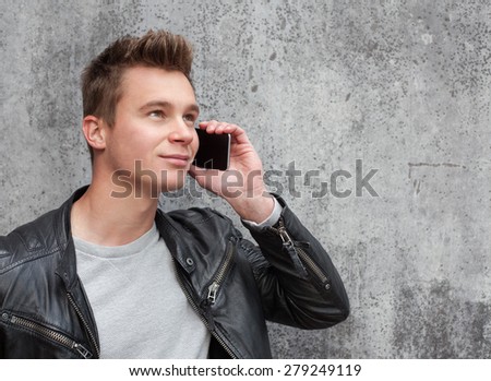 Casual young guy using smart phone