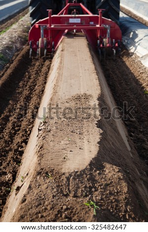 DUSSELDORF, GERMANY - CIRCA APRIL 2015: Modern agriculture machines on asparagus field