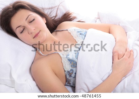 A young woman sleeps in her bed. All on white background.