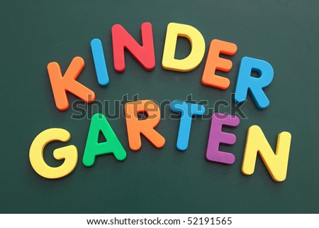 The word kindergarten built out of colored bold letters on a blackboard.