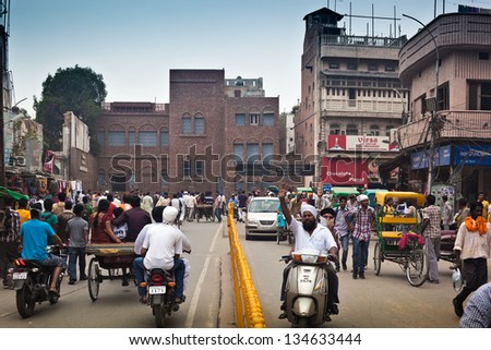 AMRITSAR, INDIA - AUGUST 8: Crowd of local people move along Golden Temple Road on August 8, 2012 in Amritsar. View of Jallianwala Bagh Martyr\'s Memorial