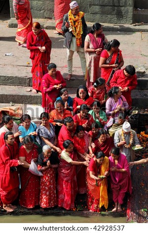 Nepalese people in sad ceremony of last farewell after cremation on ghat of holy Bagmati river in Pashupatinath, Kathmandu, Nepal