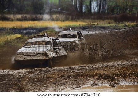 Action Auto Racing on Off Road Auto Racing  Two Race Cars Wrestling For Survival Stock Photo