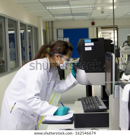 scientist looking at the microscope slide in the life science research laboratory