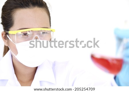Chemist holding sample of liquid in lab or laboratory