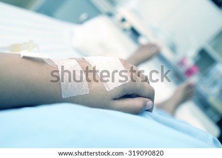 patient in hospital with saline intravenous (iv)
