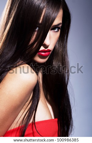 portrait of a beautiful brunette woman with red lips, focus on lips