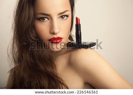 beautiful woman portrait with red lipstick on her shoulder, studio shot