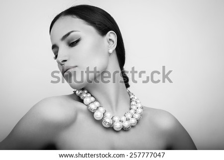 beautiful woman portrait with stylish pearl necklace, black and white
