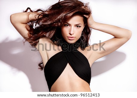 beautiful long brown hair woman with hand in hair, studio fashion portrait