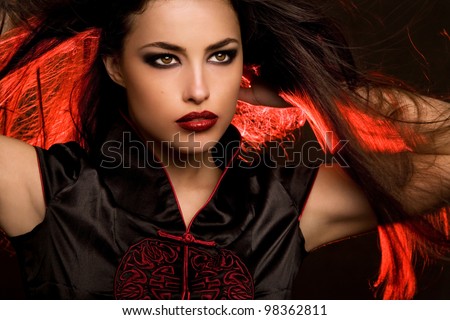 beautiful woman portrait with red lips and hair back light, studio closeup