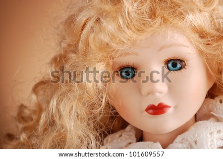 porcelain doll with blonde hair and blue eyes