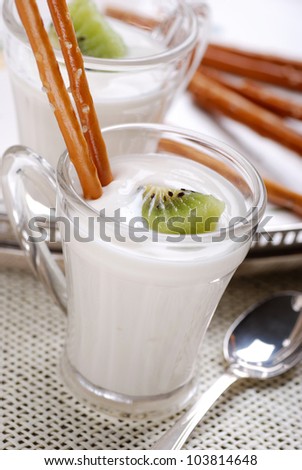 yogurt with kiwi in glass cup on the table