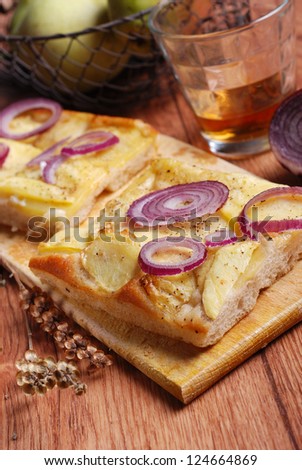 flat bread with potatoes and onions on the wooden table