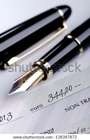 a bank check with fountain pen